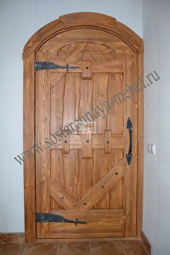 Входная арочная дверь из массива дерева – фото